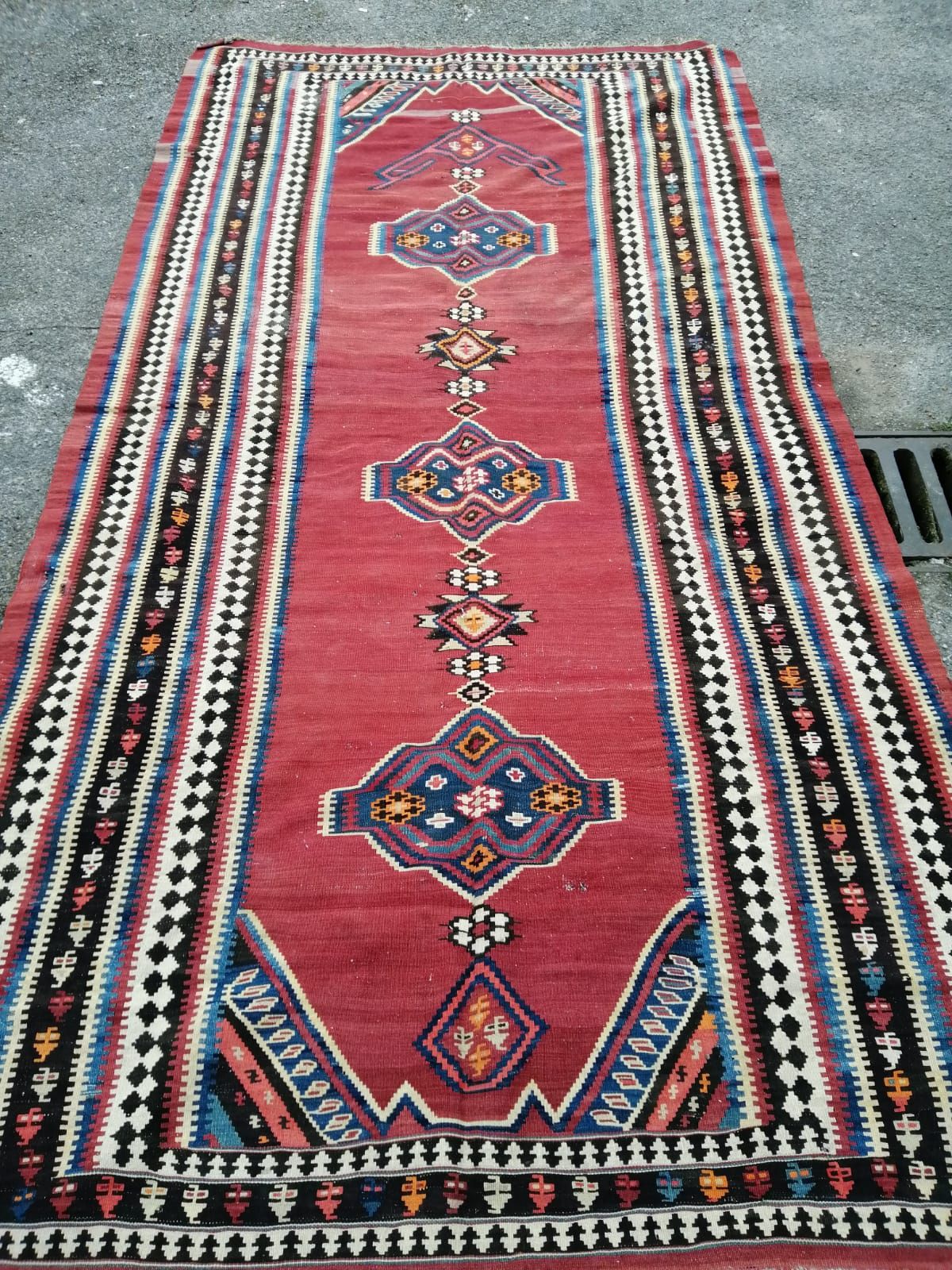 A Kelim flatweave carpet, 340 x 172cm (holed)